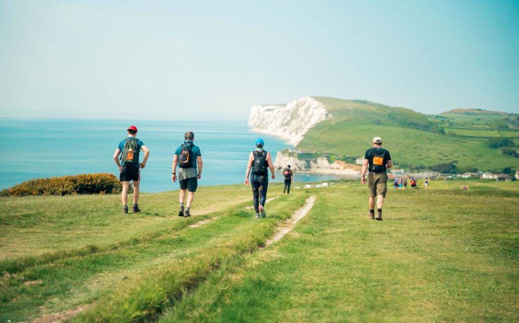 People walking on cliffs near the sea