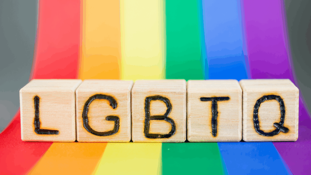 LGBTQ block with rainbow behind